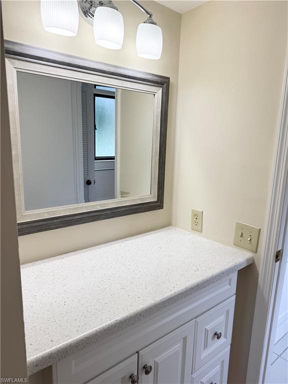 124 Cypress Way East, Unit E3 Naples, FL 34110 - Photo 5 of 22 a bathroom with a sink and a mirror