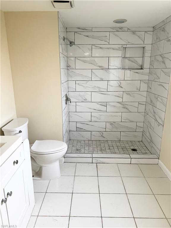 124 Cypress Way East, Unit E3 Naples, FL 34110 - Photo 6 of 22 a bathroom with a toilet and a shower