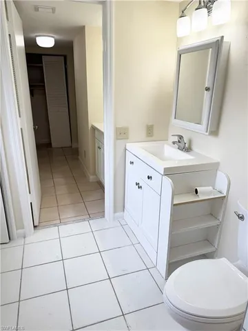 a bathroom with a sink a toilet a mirror and vanity