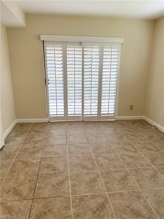 124 Cypress Way East, Unit E3 Naples, FL 34110 - Photo 8 of 22 a view of an empty room with a window