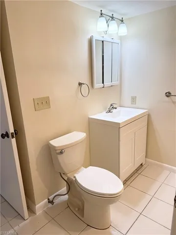 a white toilet sitting next to a bathroom sink