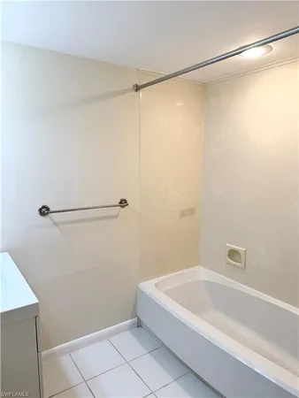 a bathroom with a shower and a bath tub