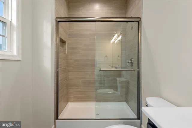 a bathroom with a glass shower door