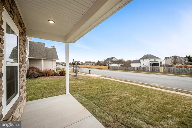 a view of a patio with a table and chairs