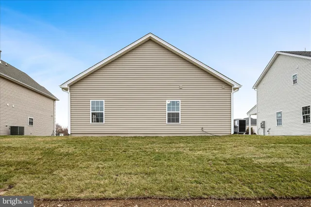a house that has a big yard plants and large trees