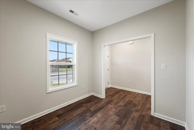 a view of room with window and hardwood floor