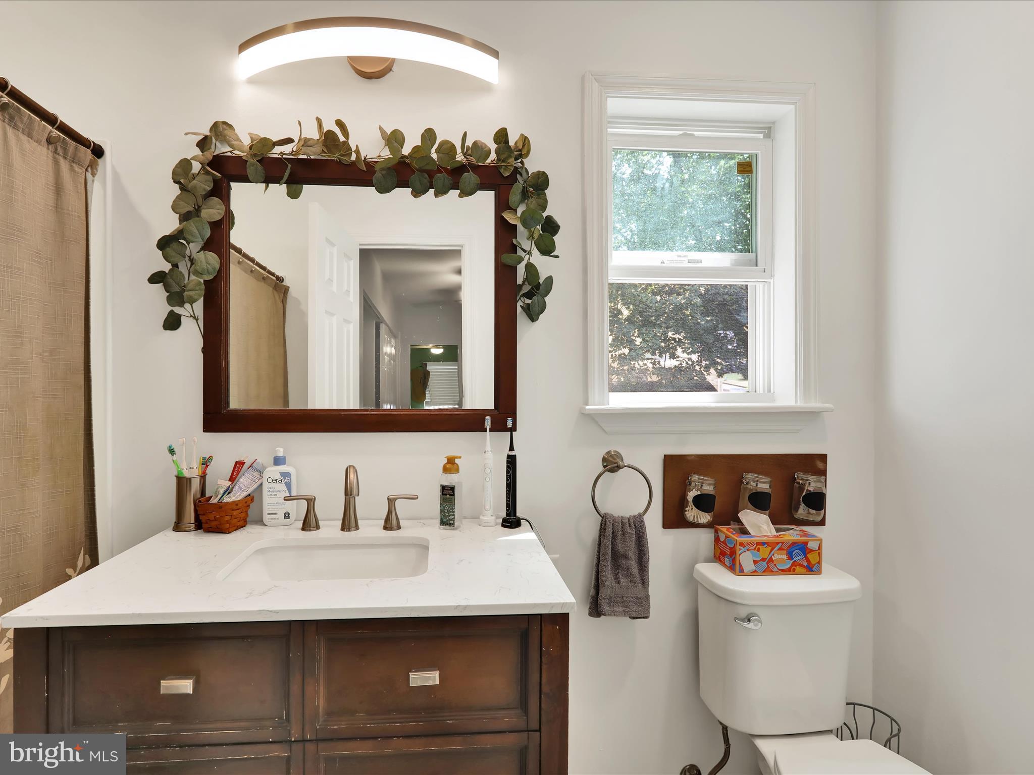 1212 Deer Run Reading, PA 19606 - Photo 22 of 29 a bathroom with a sink a mirror and a window