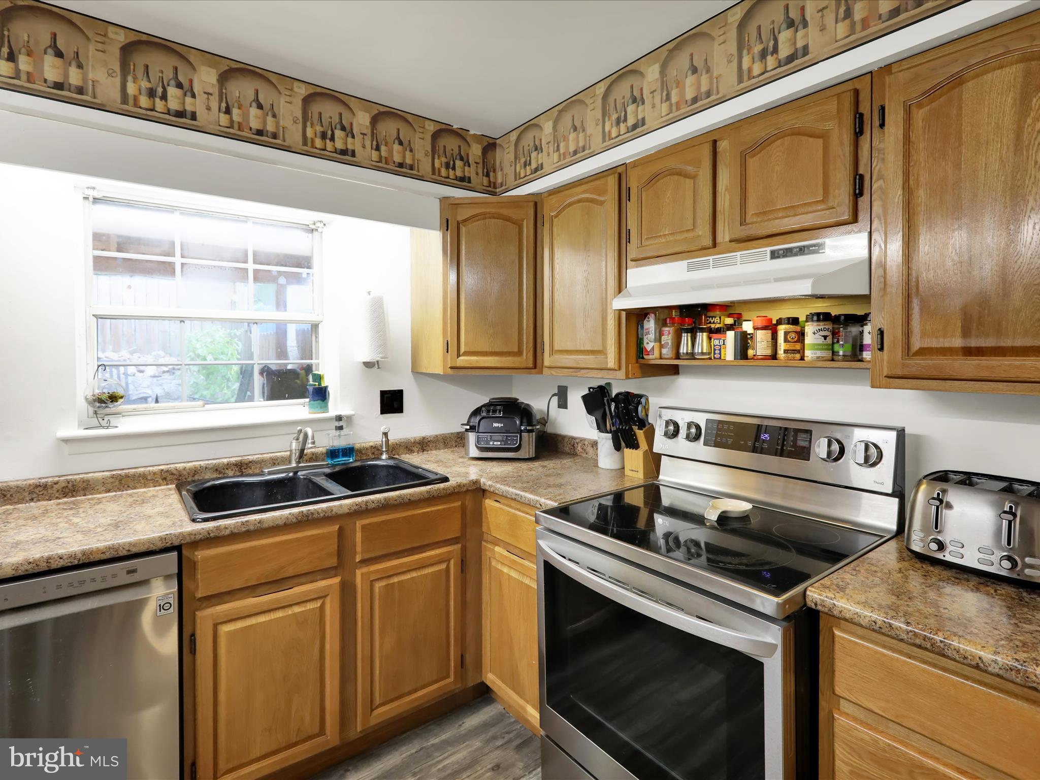 1212 Deer Run Reading, PA 19606 - Photo 10 of 29 a kitchen with stainless steel appliances granite countertop a sink a stove and cabinets