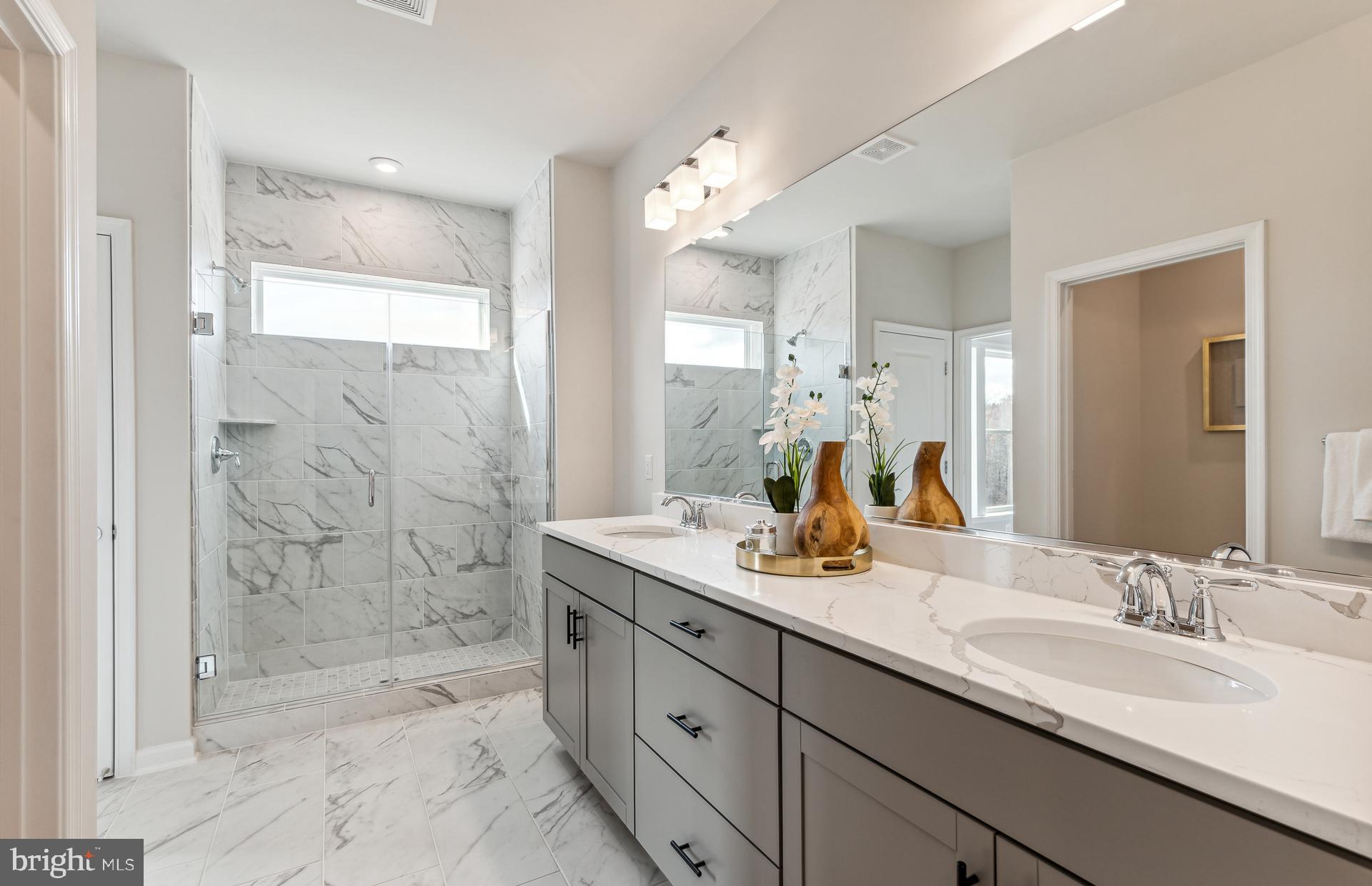 42841 Exeter Spg Terrace Leesburg, VA 20176 - Photo 7 of 38 a bathroom with a granite countertop sink mirror and shower
