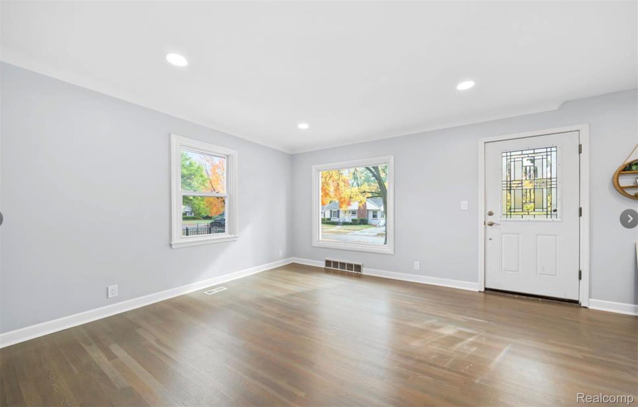 4214 Berkshire Road Royal Oak, MI 48073 - Photo 3 of 27 Spacious living area featuring polished wood-finish flooring, recessed lighting, and crisp white trim