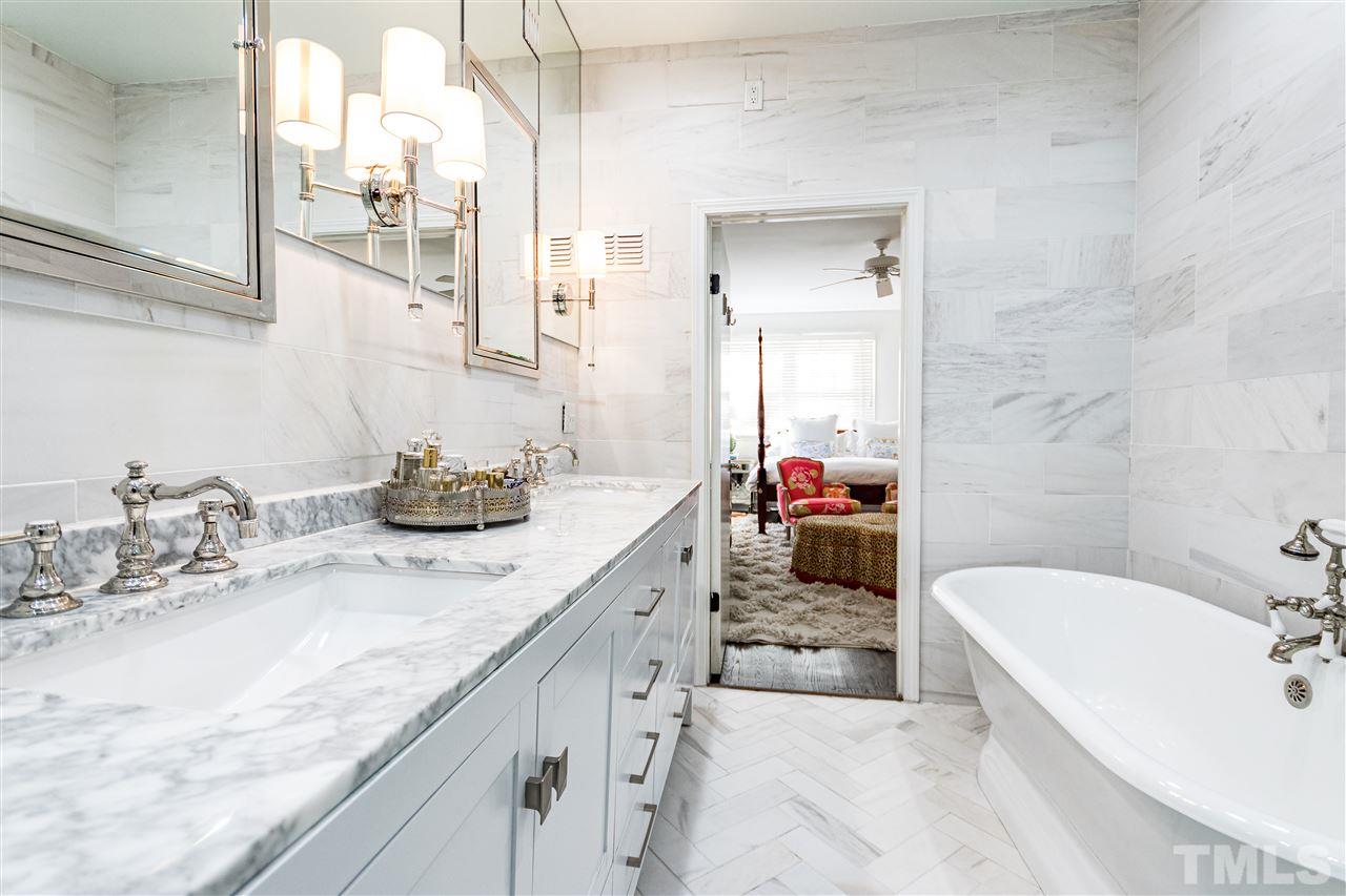 1114 Harvey Street Raleigh, NC 27608 - Photo 17 of 24 a en suite bathroom with a granite countertop tub sink and mirror