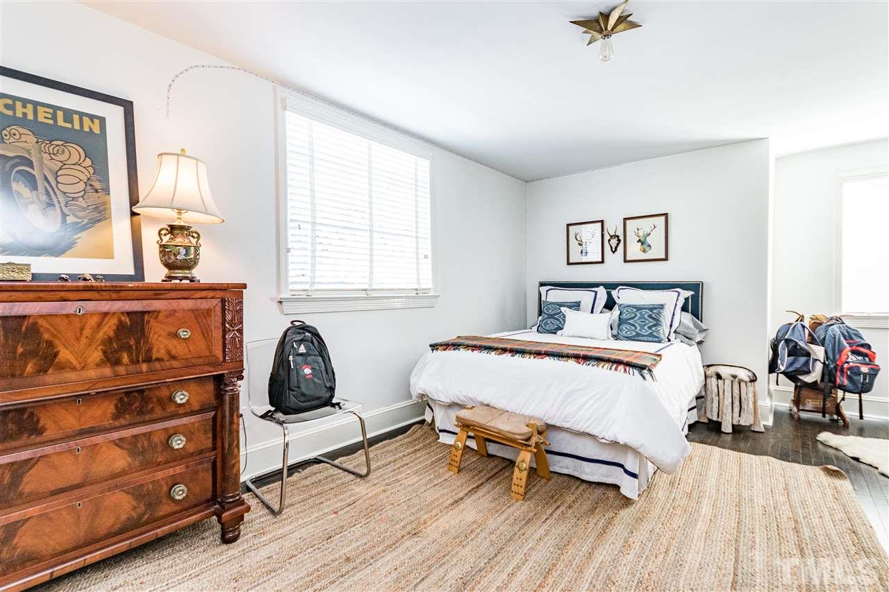 1114 Harvey Street Raleigh, NC 27608 - Photo 19 of 24 a bedroom with furniture and a wooden floor