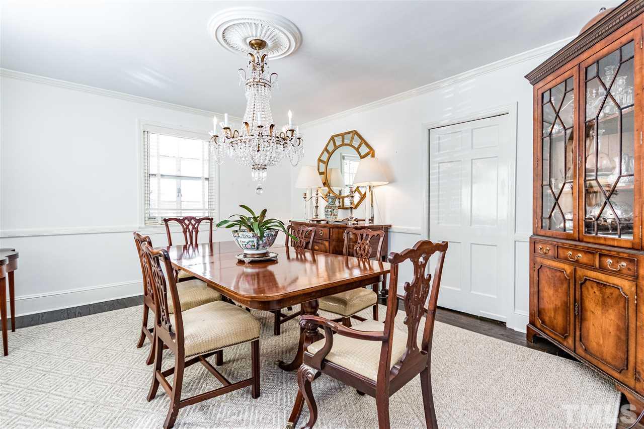 1114 Harvey Street Raleigh, NC 27608 - Photo 5 of 24 a view of a dining room with furniture a chandelier and wooden floor