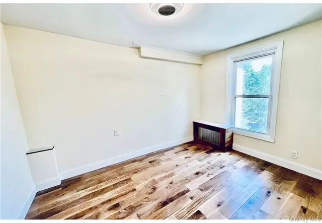 a view of a room with wooden floor and fan