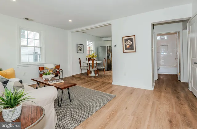 a living room with furniture and wooden floor