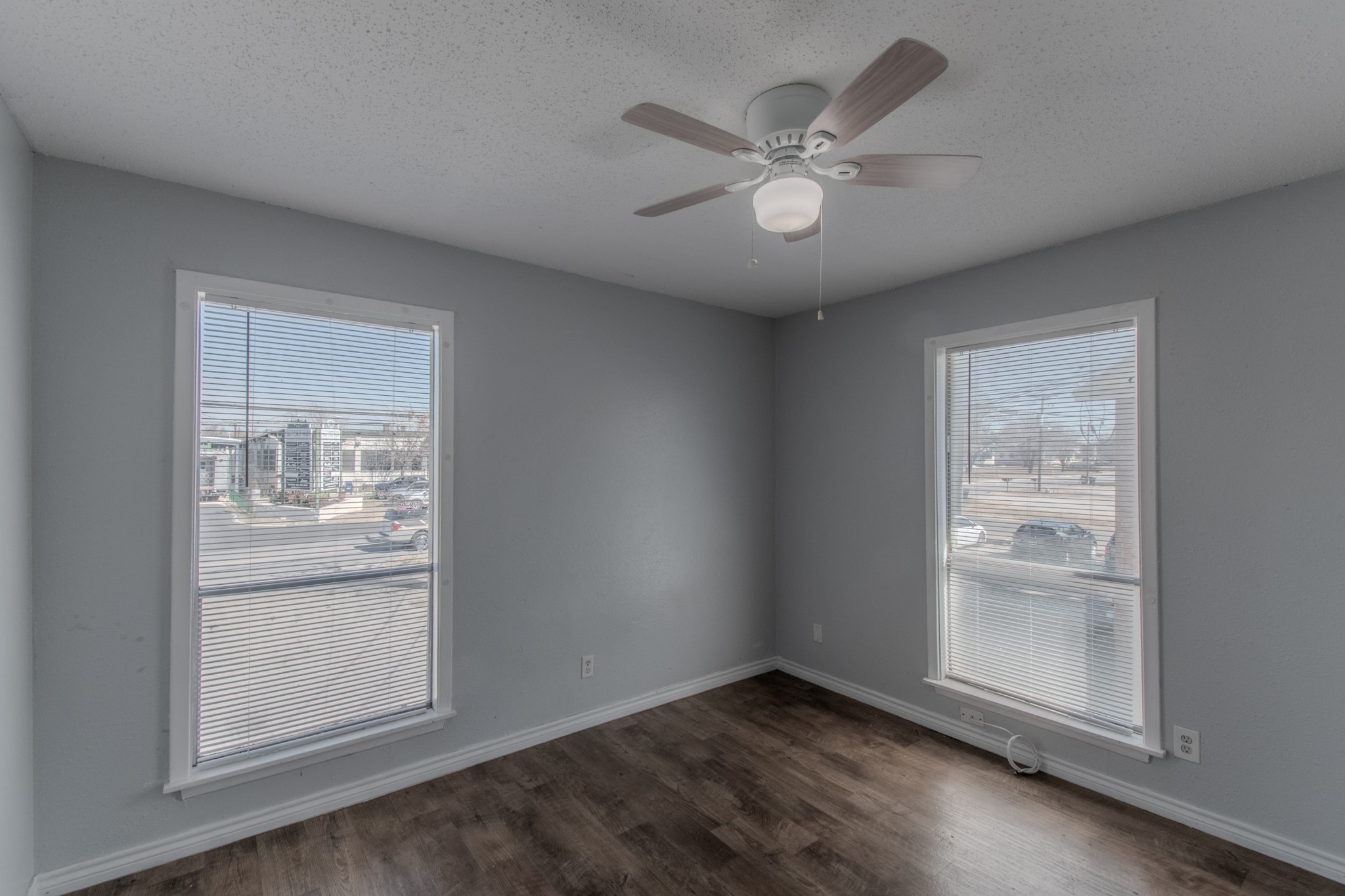 100 Uhland Road, Unit 3 San Marcos, TX 78666 - Photo 16 of 26 an empty room with wooden floor fan and windows