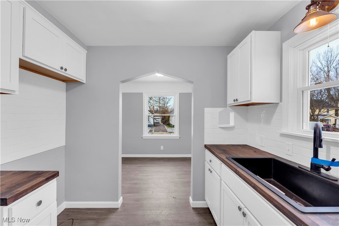 953 Whitby Road Cleveland Heights, OH 44112 - Photo 9 of 27 Kitchen with wooden counters, backsplash, and white cabinetry