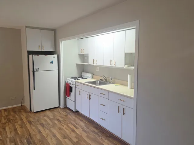 a kitchen with a refrigerator a sink and a window