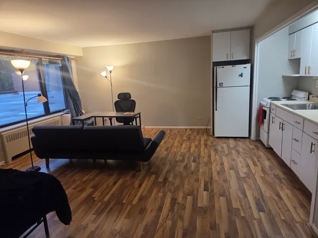 a living room with a bed and furniture