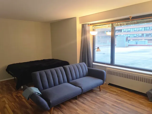 a living room with furniture and a floor to ceiling window