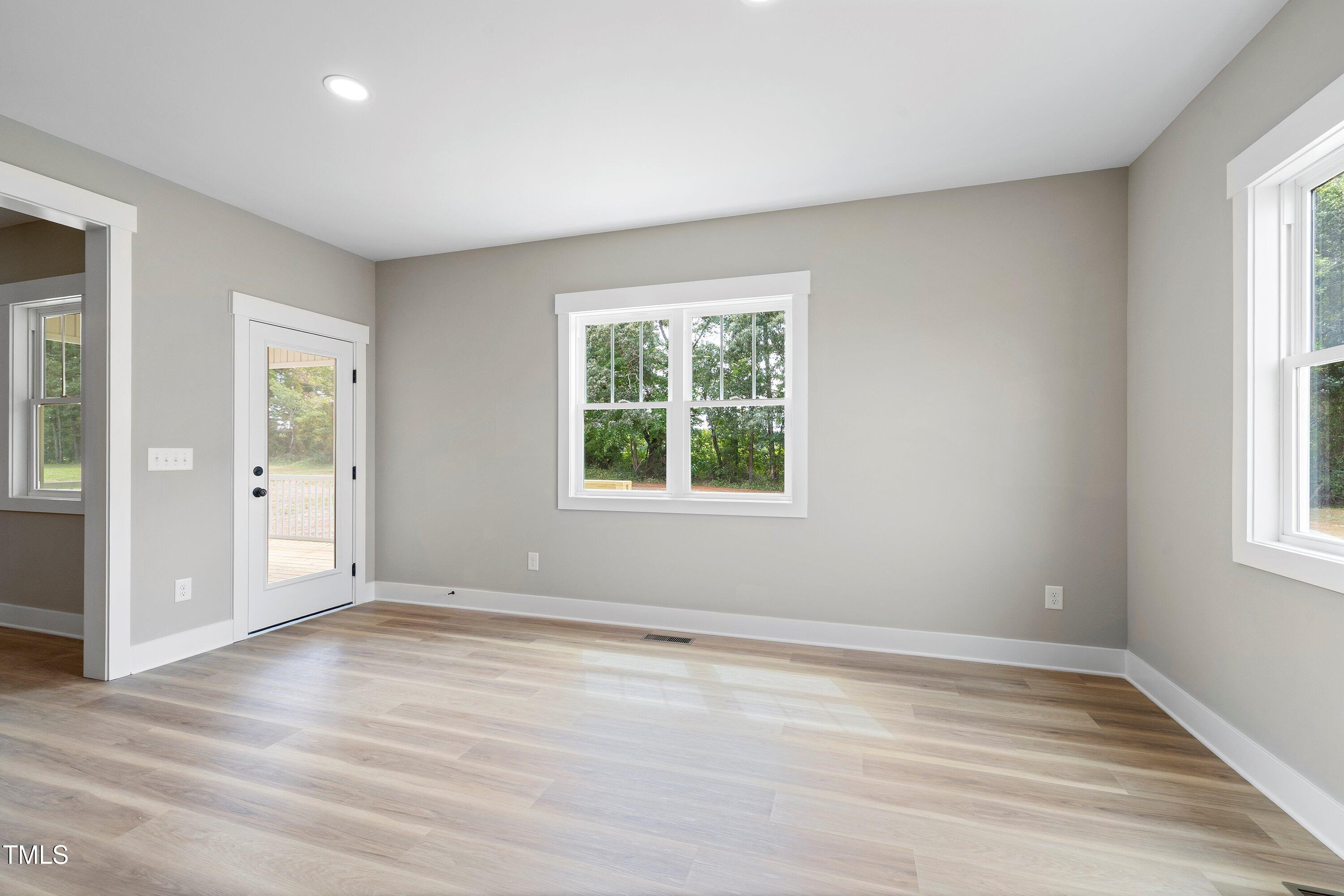9293 Bear Run Lane Middlesex, NC 27557 - Photo 13 of 36 an empty room with wooden floor and windows