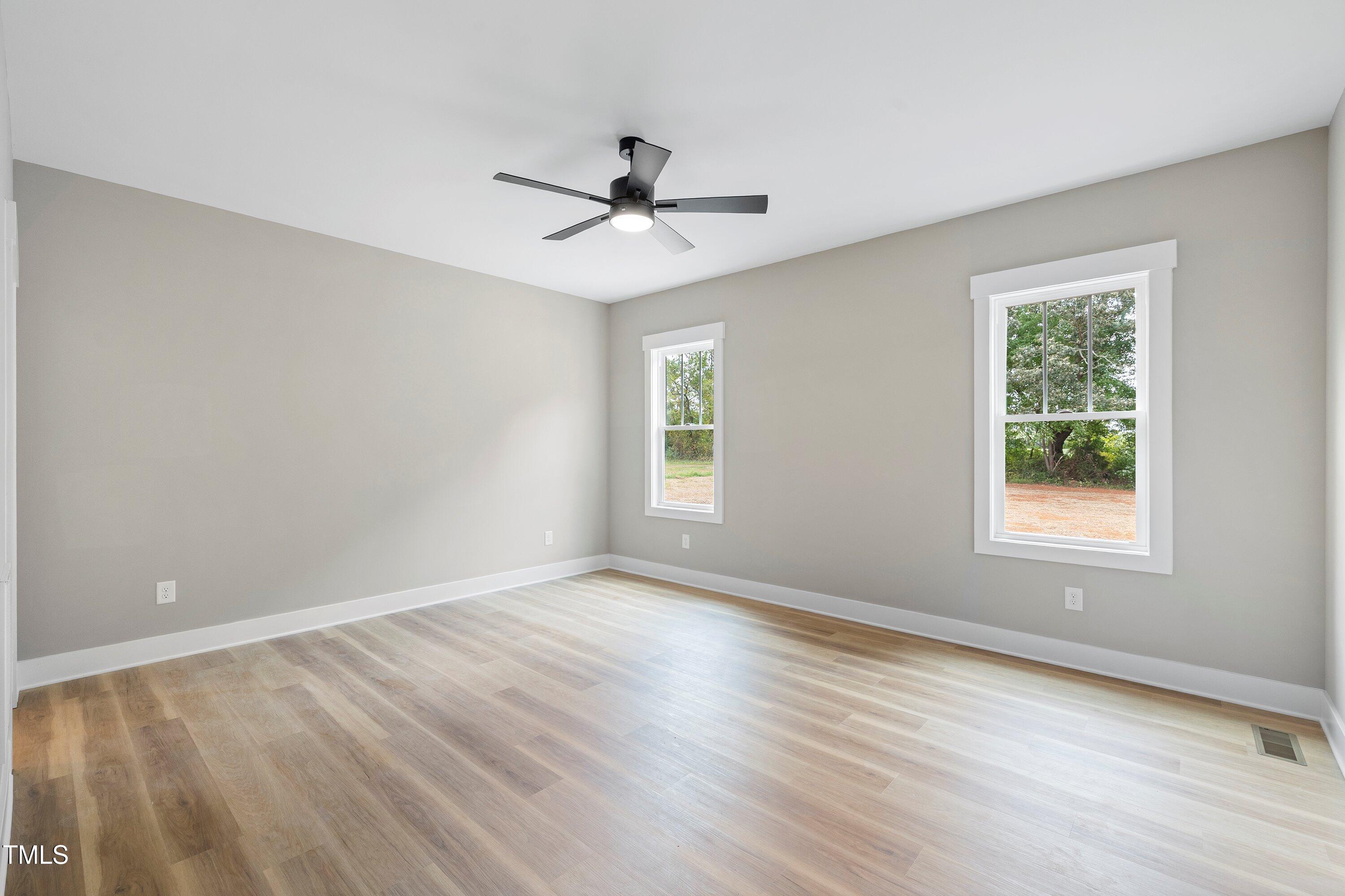 9293 Bear Run Lane Middlesex, NC 27557 - Photo 15 of 36 a view of an empty room with a window and wooden floor