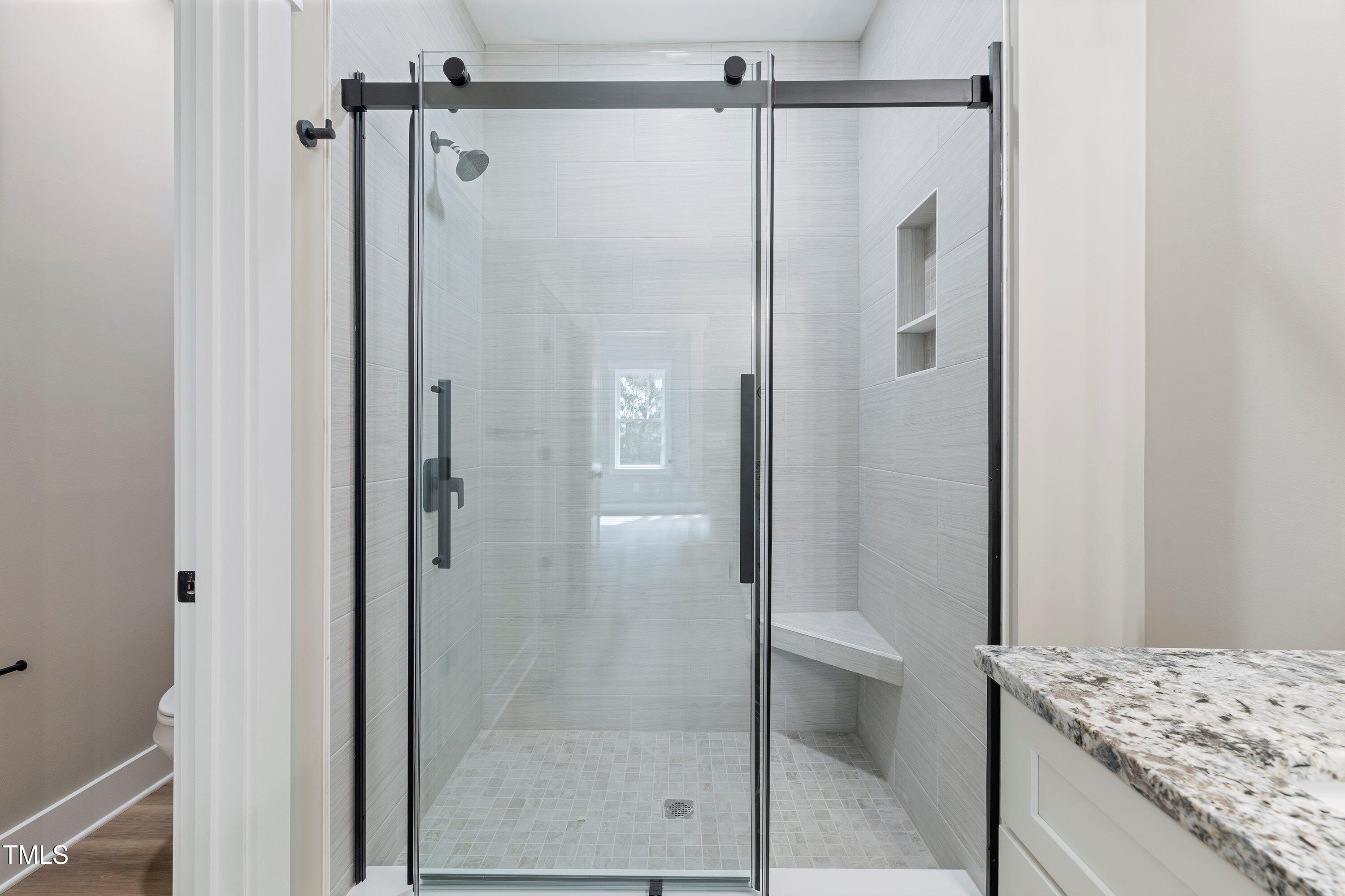 9293 Bear Run Lane Middlesex, NC 27557 - Photo 18 of 36 a bathroom with a granite countertop shower mirror and a sink