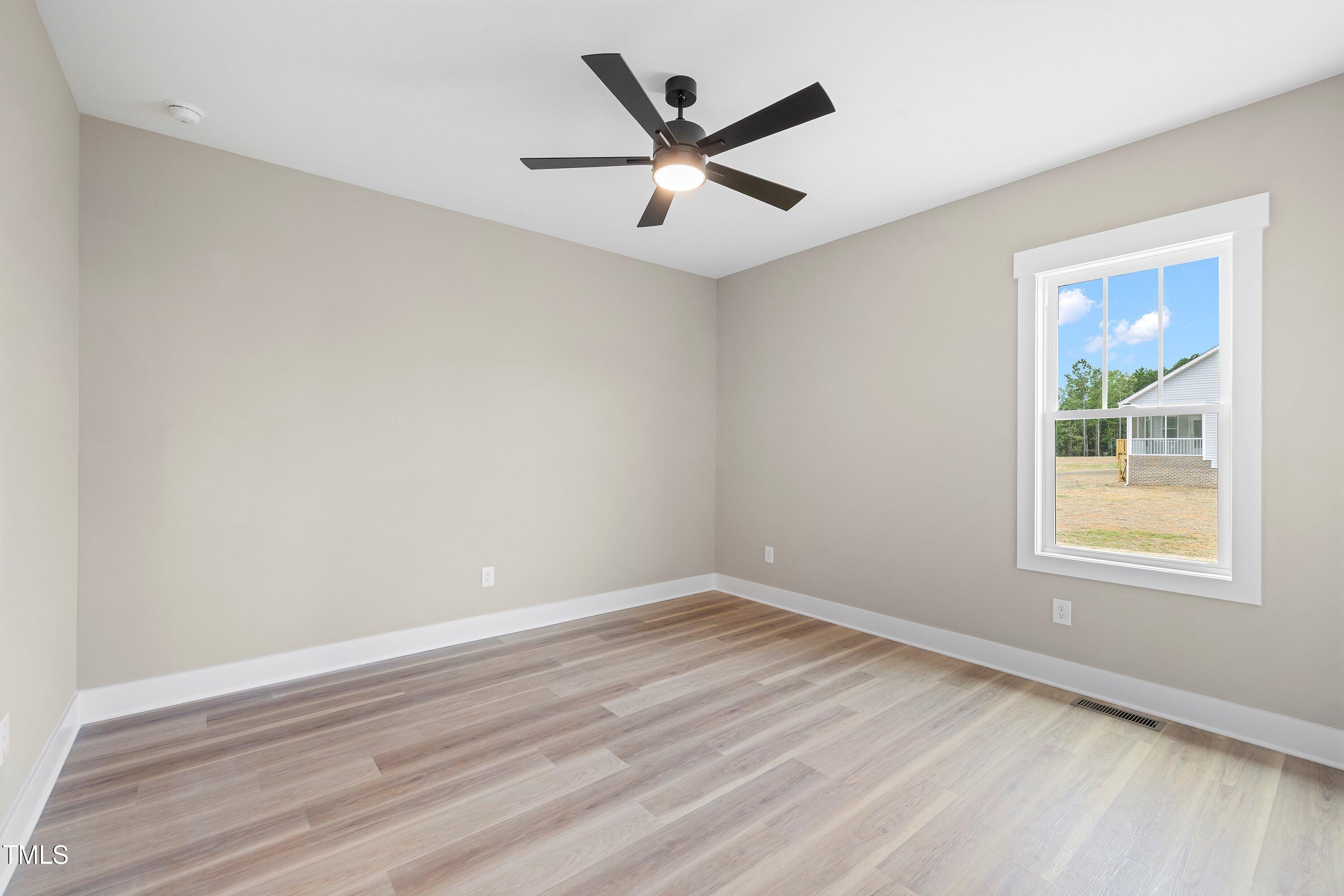 9293 Bear Run Lane Middlesex, NC 27557 - Photo 24 of 36 an empty room with wooden floor and windows