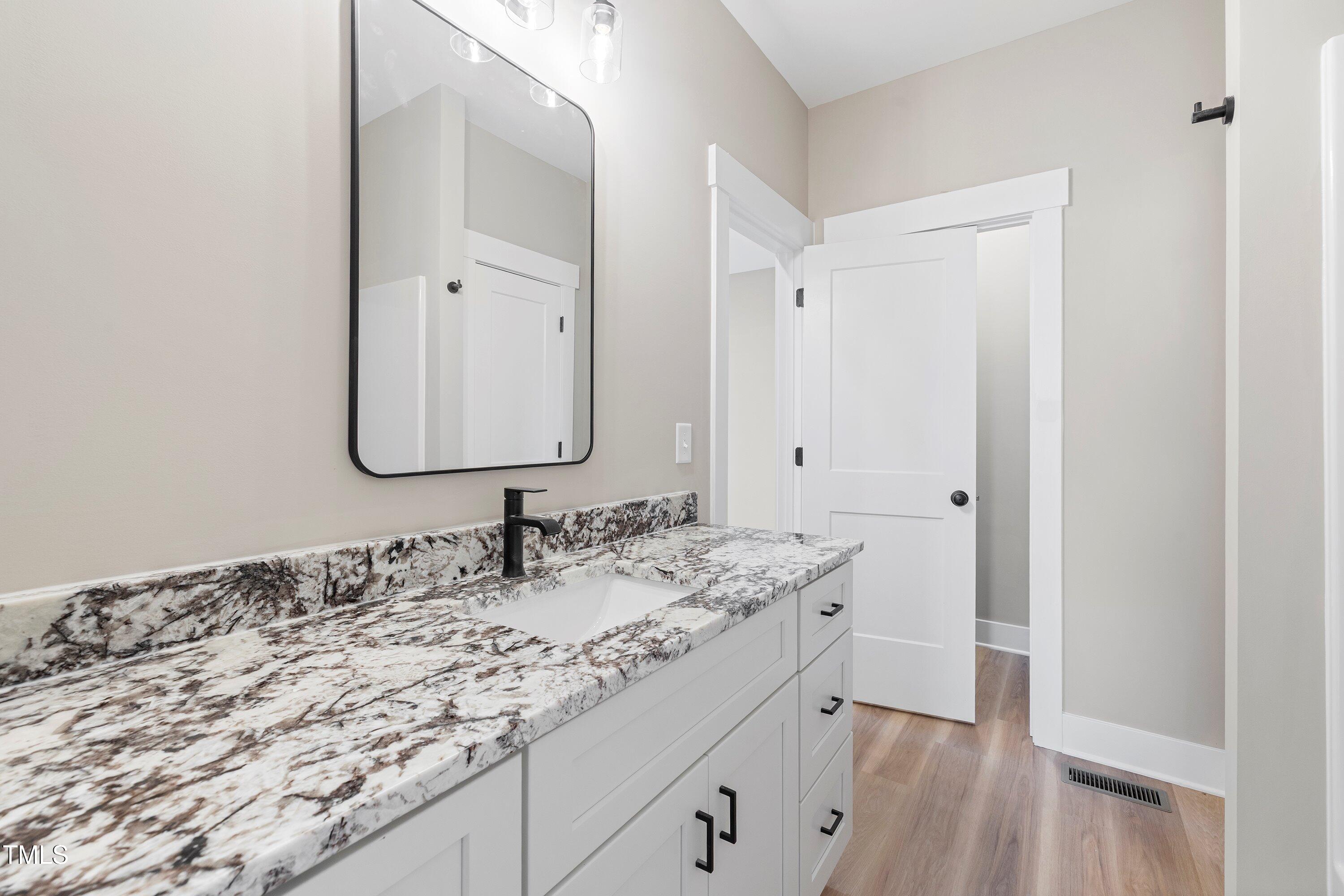 9293 Bear Run Lane Middlesex, NC 27557 - Photo 26 of 36 a bathroom with a sink and a mirror