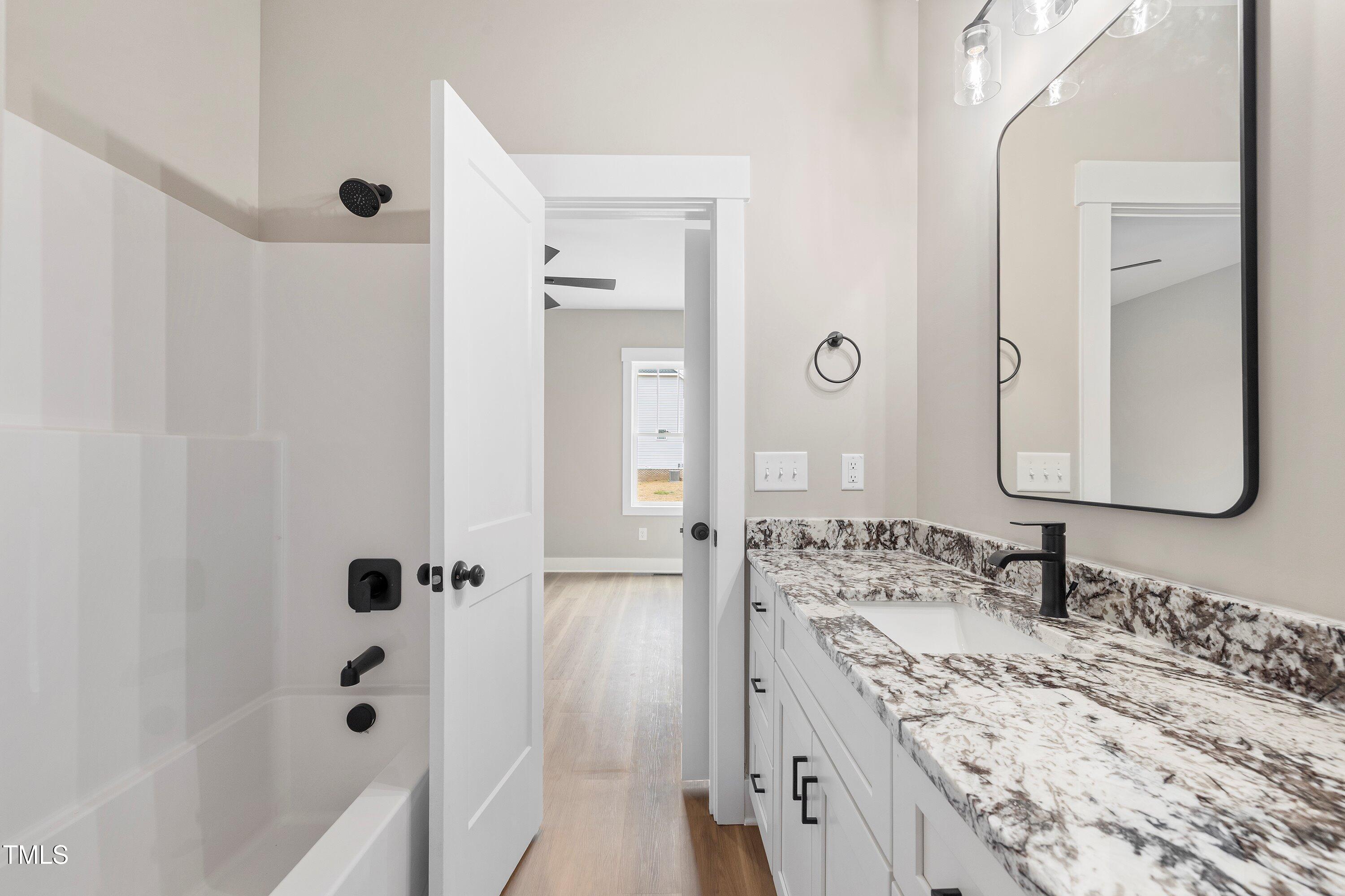 9293 Bear Run Lane Middlesex, NC 27557 - Photo 27 of 36 a bathroom with a granite countertop sink double vanity and shower
