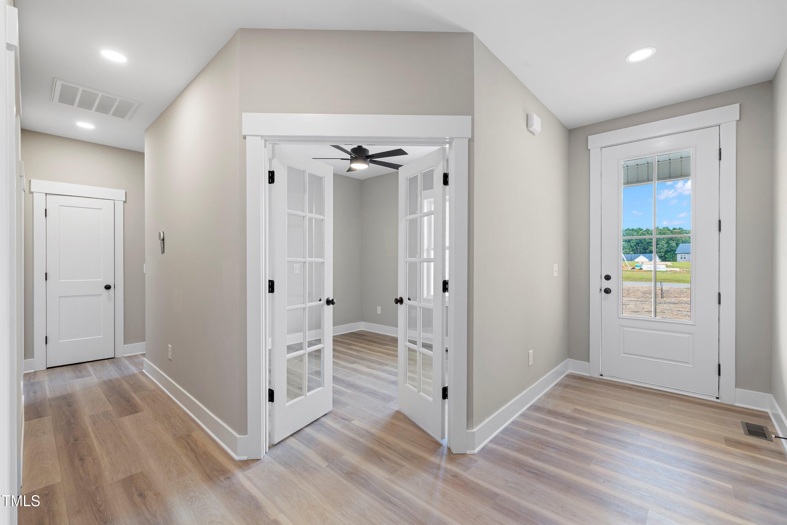 9293 Bear Run Lane Middlesex, NC 27557 - Photo 4 of 36 an empty room with wooden floor and a bathroom
