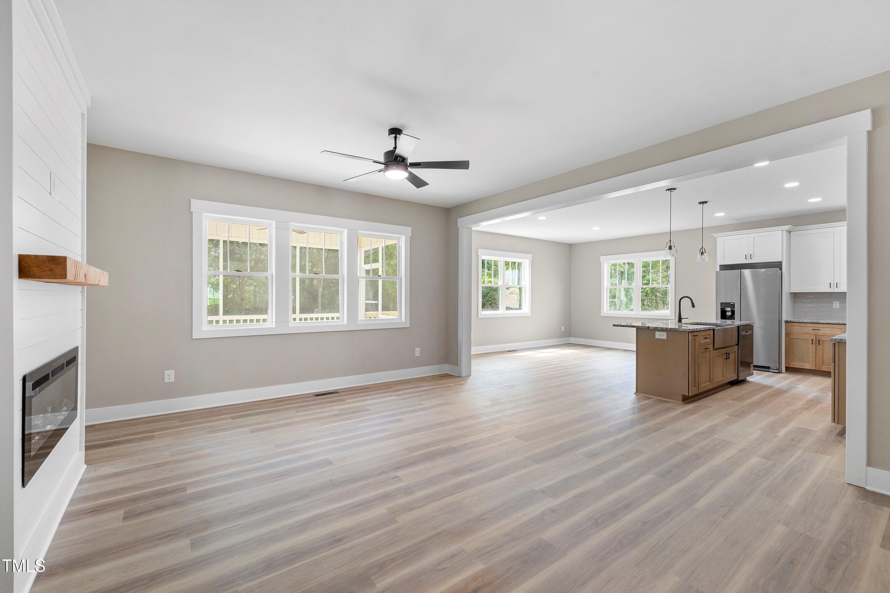 9293 Bear Run Lane Middlesex, NC 27557 - Photo 6 of 36 a view of an empty room with a window and fireplace