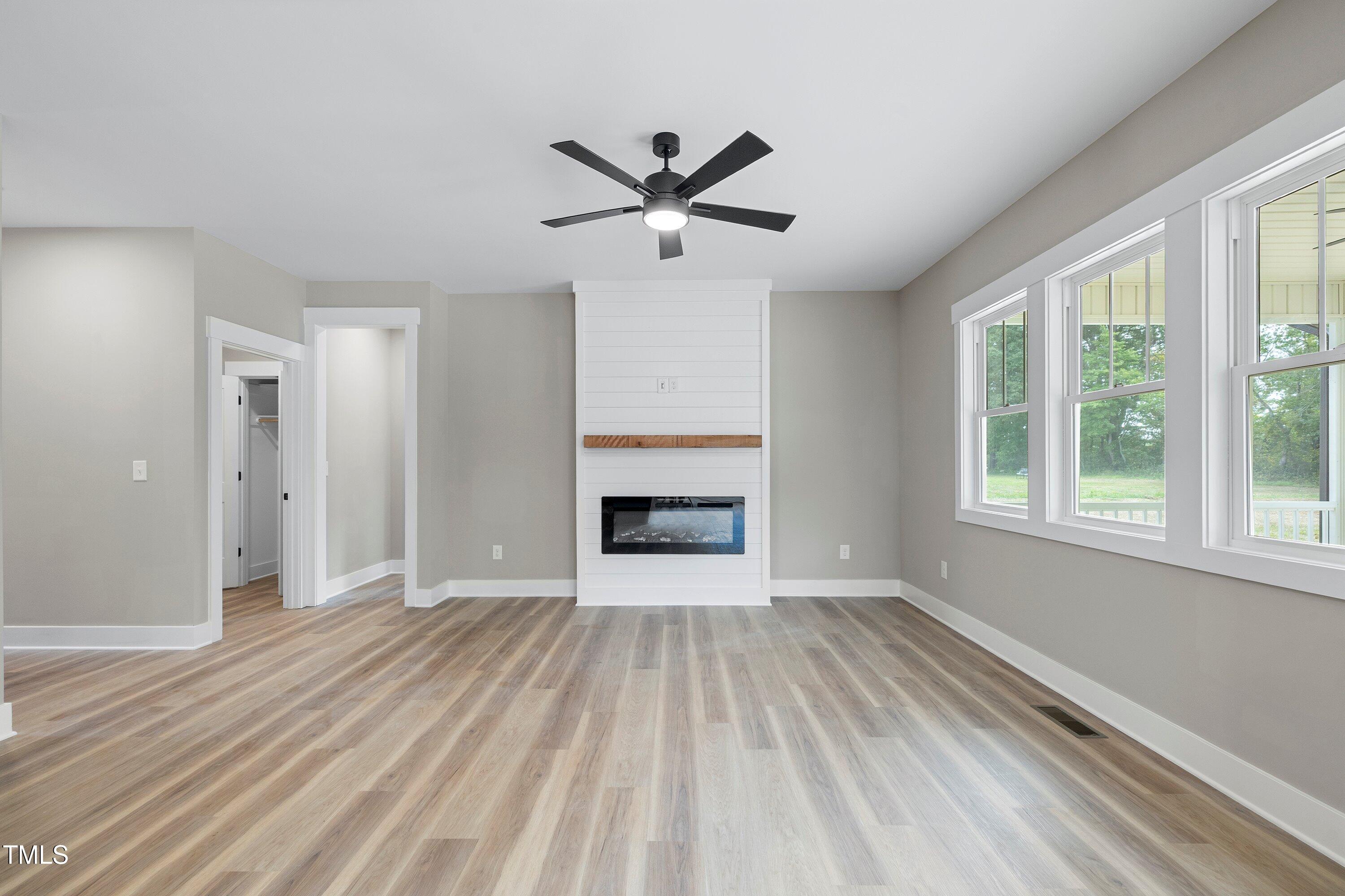 9293 Bear Run Lane Middlesex, NC 27557 - Photo 7 of 36 a view of an empty room with a window and a kitchen