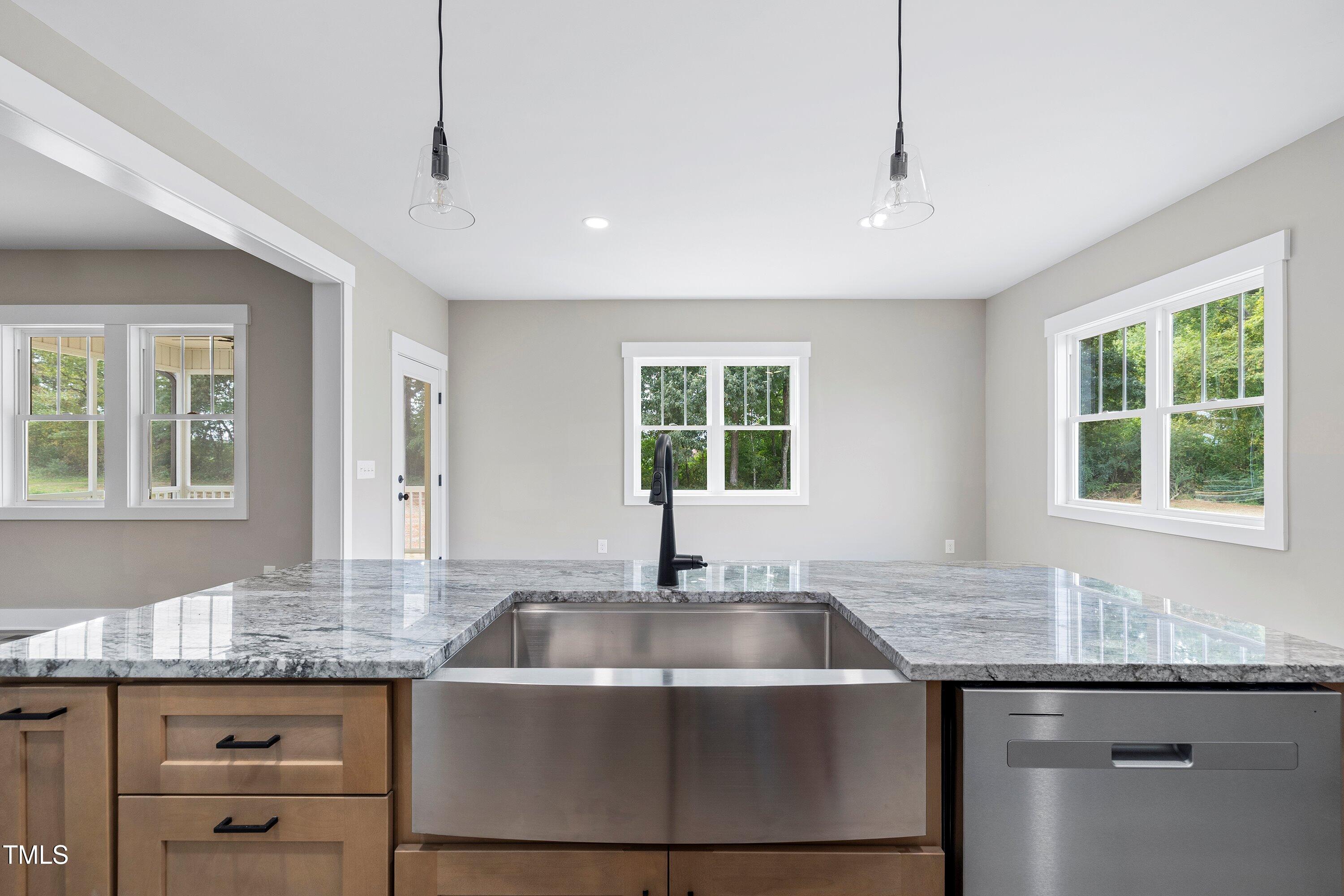 9293 Bear Run Lane Middlesex, NC 27557 - Photo 9 of 36 a kitchen with granite countertop a sink and window