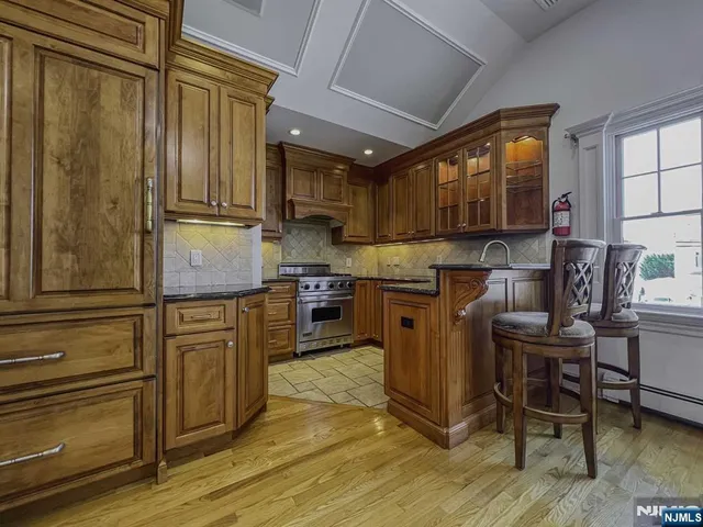 a view of a livingroom with furniture a flat screen tv and a wooden floor