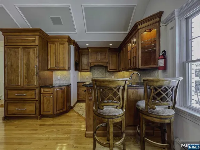 a bathroom with a granite countertop sink toilet a mirror and shower