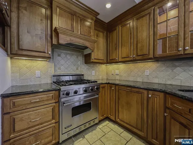 an empty room with wooden floor and fan