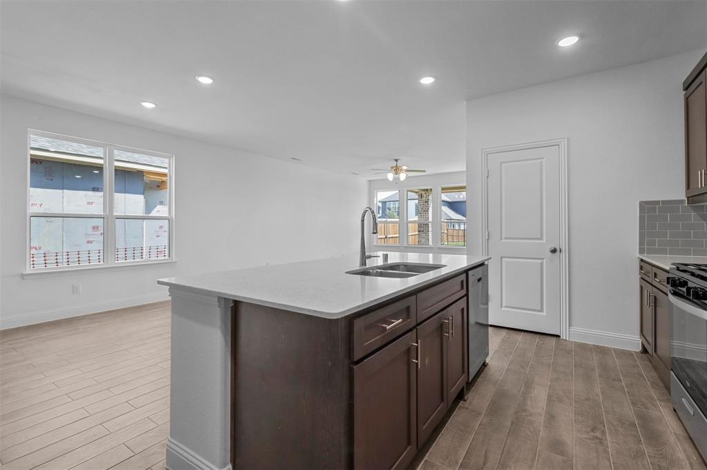 704 Amenduni Lane Anna, TX 75409 - Photo 7 of 19 a kitchen with granite countertop a stove and a sink