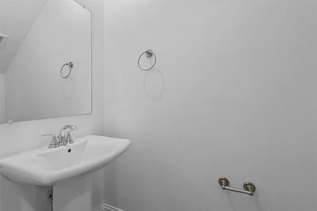 a bathroom with a sink and mirror