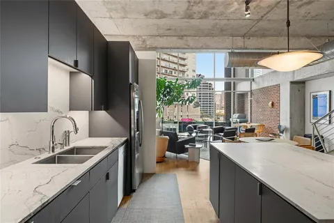 a kitchen with counter top a sink cabinets and appliances