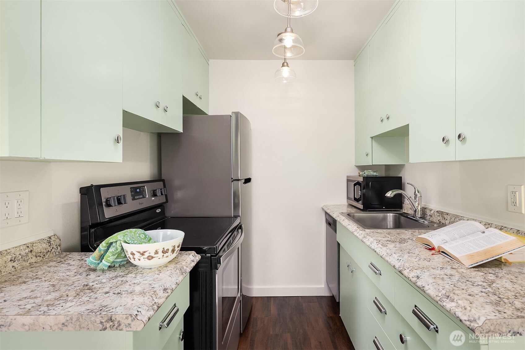 8701 35th Avenue Northeast, Unit 9 Seattle, WA 98115 - Photo 4 of 19 a kitchen with stainless steel appliances granite countertop a sink a stove a refrigerator a counter top space and cabinets