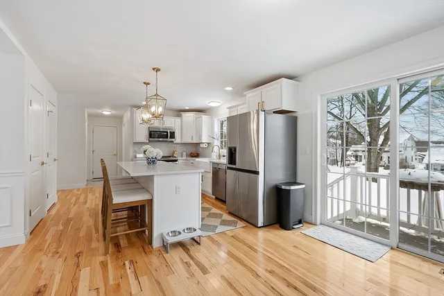a kitchen with stainless steel appliances a refrigerator and a stove top oven