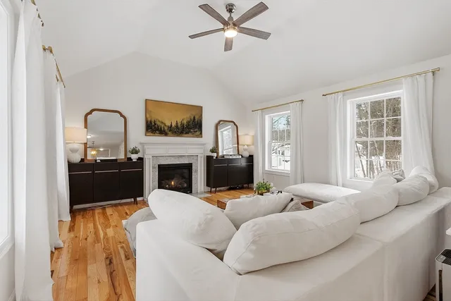 a living room with furniture a fireplace and a flat screen tv