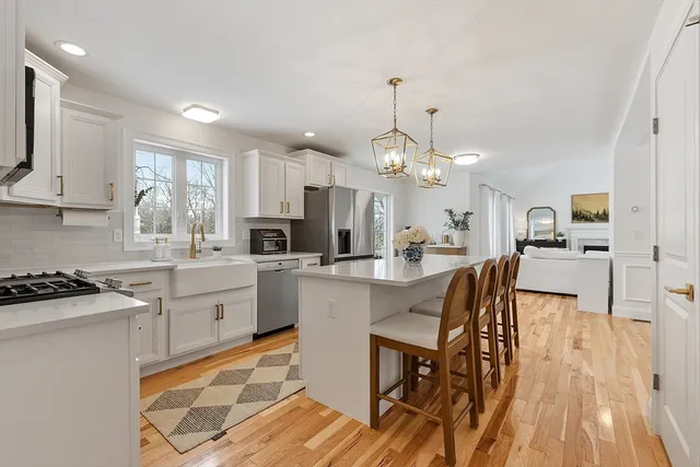 a kitchen with stainless steel appliances kitchen island granite countertop a sink and cabinets