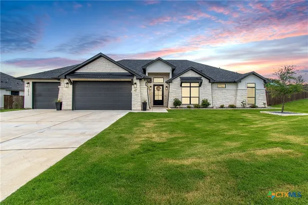 a front view of a house with a yard