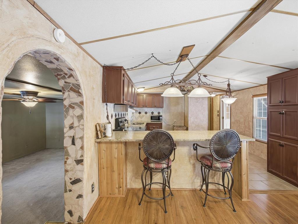 196 Perch Road Bowie, TX 76230 - Photo 6 of 33 a room with lots of wooden furniture and wooden floor