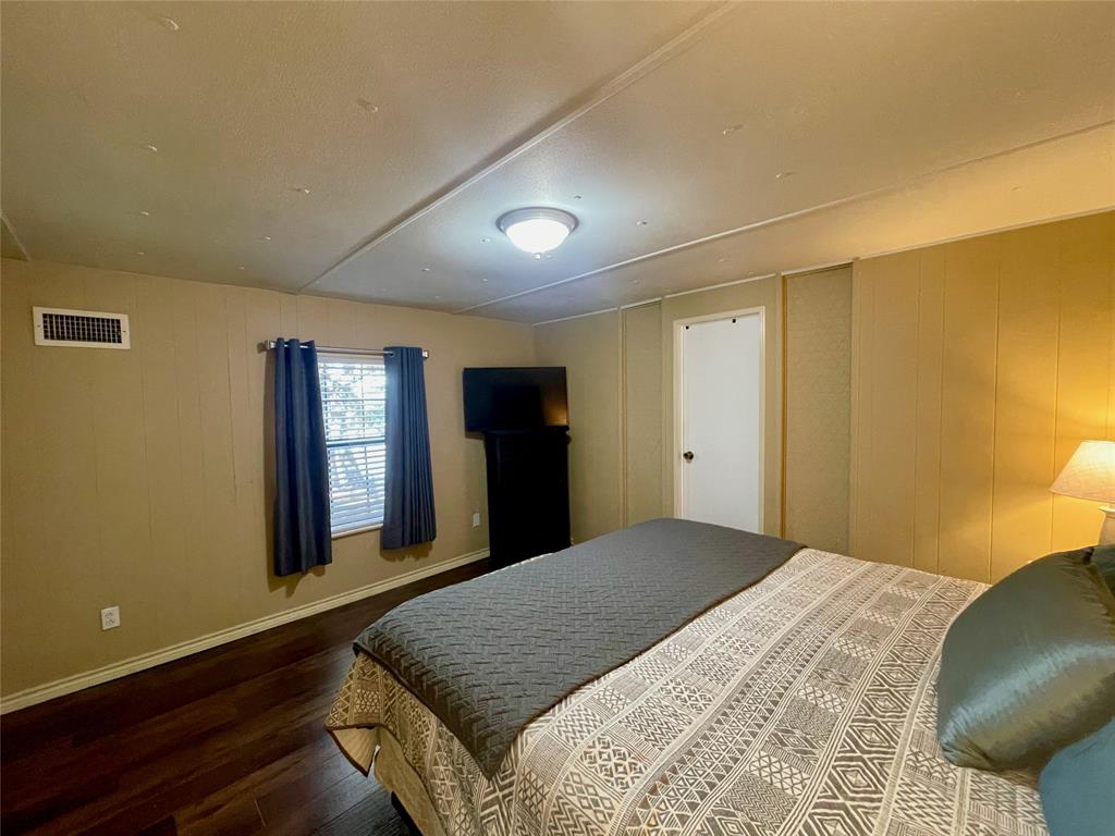 2334 San Bar Road, Unit 50 Graford, TX 76449 - Photo 20 of 40 a bedroom with a bed and a dresser