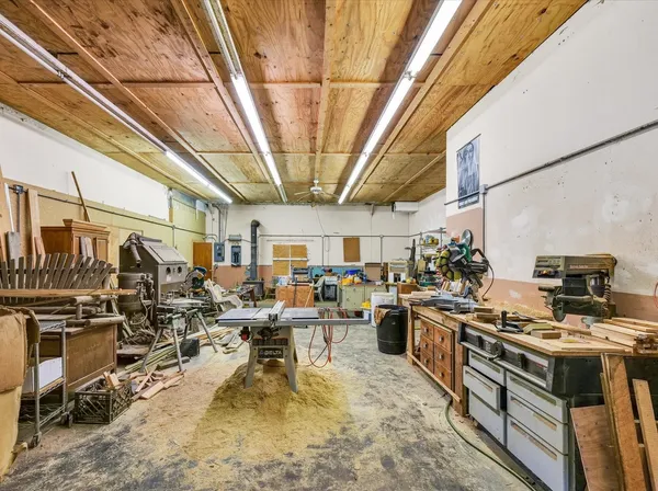 a view of a room with lots of furniture and clutter