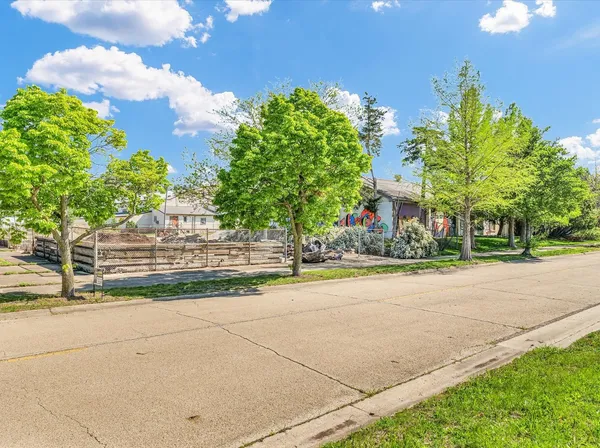 a front view of a house with a yard and a garage