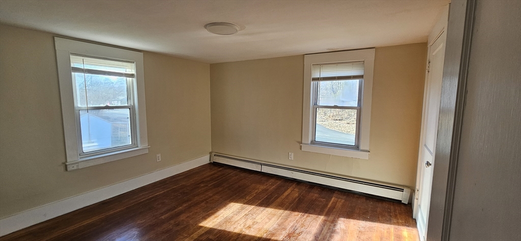378 Boston Road Monson, MA 01069 - Photo 11 of 22 a view of an empty room with wooden floor and a window